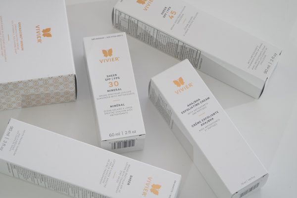 Vivier skin care products packaging Photo showing various packages of Vivier brand skin care products, including sunscreens and exfoliating creams, arranged on a white surface.